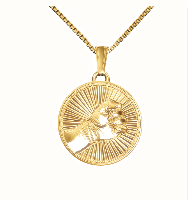Sunburst medallion of a baby hand in 18k gold